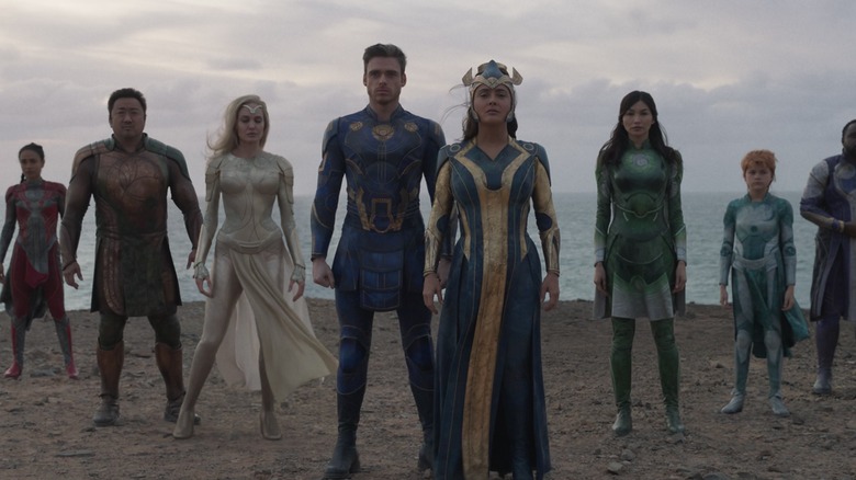 The Eternals stand side-by-side on a beach, led by Salma Hayek Ajak, in Marvel Studios' Eternals