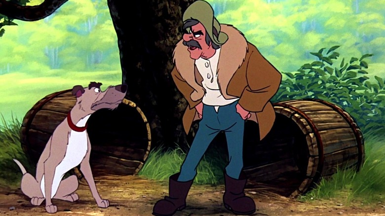 Amos puts his hands on his hips and looks toward the right as he stands next to Chief who sits and looks toward him while outside in The Fox and the Hound