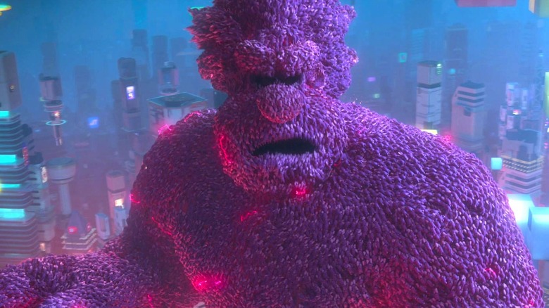 Evil Ralph stands in front of buildings made up of portions of the internet while looking ahead in Ralph Breaks the Internet