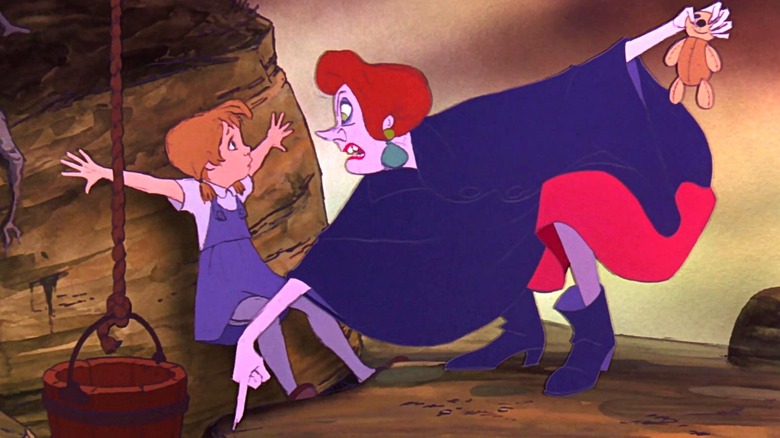 Madame Medusa stares at Penny as she points down toward a hole in a rock formation while holding Penny's teddy bear behind her in The Rescuers