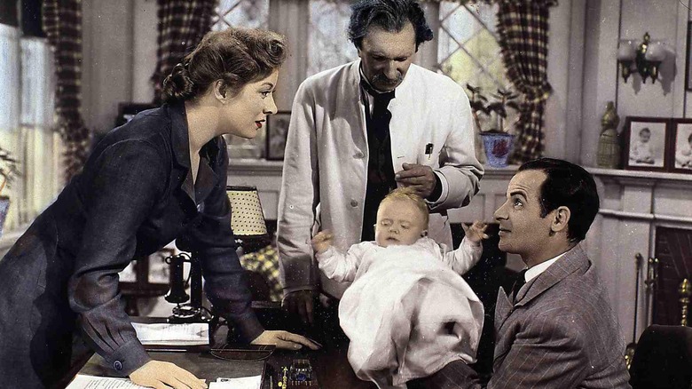 Edna Gladney (Greer Garson) looking at orphaned baby in Blossoms in the Dust