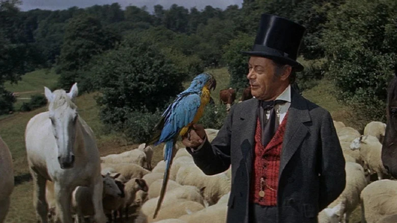 Doctor Dolittle (Rex Harrison) holding a parrot in Doctor Dolittle