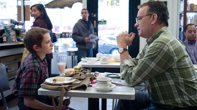 Thomas (Tom Hanks) sitting with Oskar (Thomas Horn) in Extremely Loud & Incredibly Close