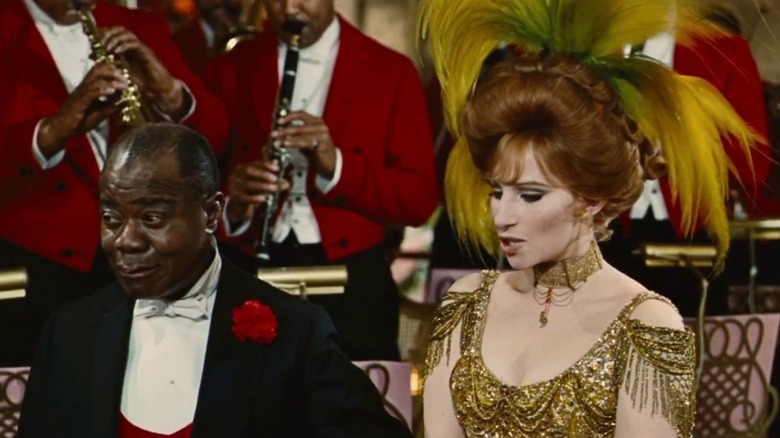 Dolly (Barbra Streisand) with the orchestra leader (Louis Armstrong) in Hello, Dolly!