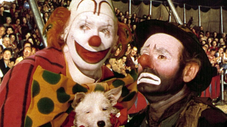 Buttons the Clown (James Stewart) holding a dog in The Greatest Show on Earth