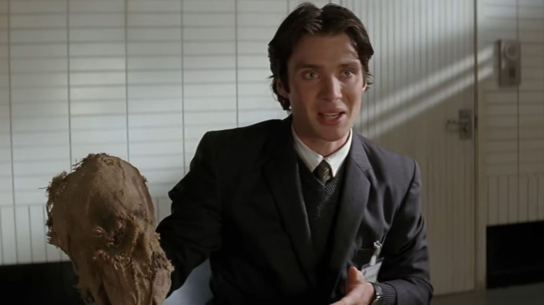 Cillian Murphy's Dr. Crane holds his Scarecrow mask in Batman Begins.