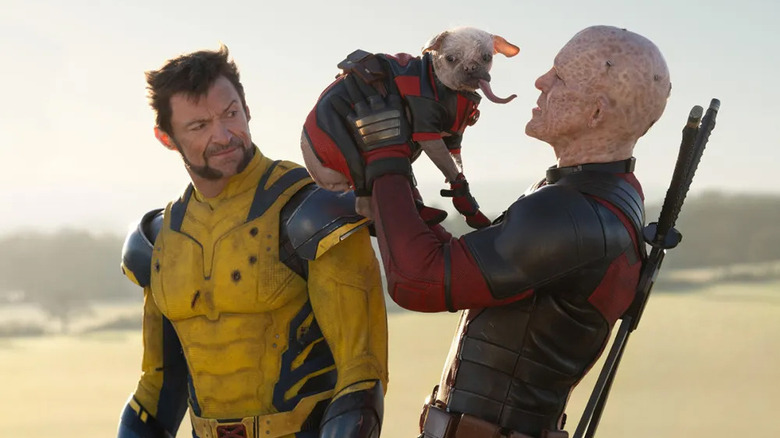 Unmasked Deadpool looking lovingly at Dogpool while Wolverine watches disapprovingly