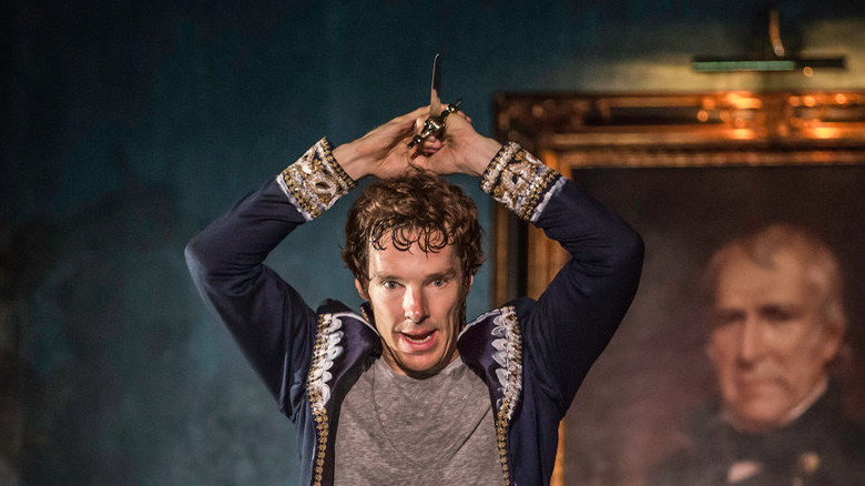 Hamlet wielding a dagger over his head