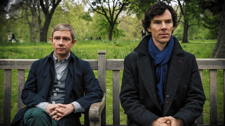 John Watson and Sherlock Holmes on a park bench
