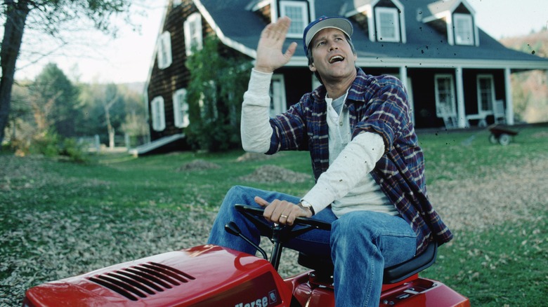 Chase waving on riding lawnmower