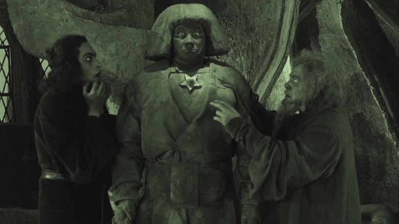 Rabbi Loew and assistant look at Golem