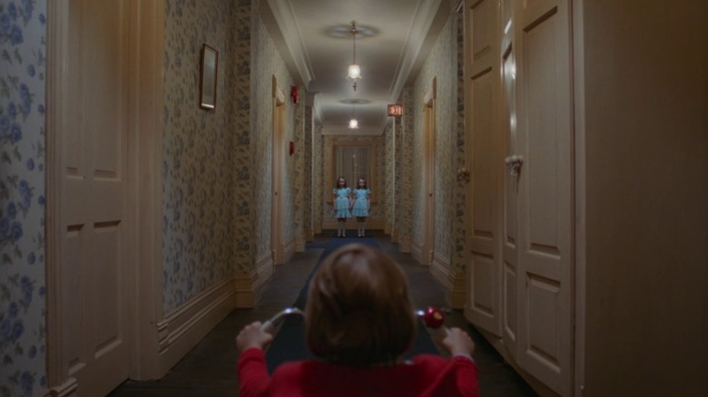 Lisa and Louise Burns as the Grady sisters and Danny Lloyd as Danny Torrance in The Shining