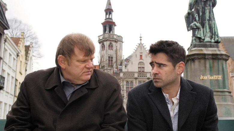 Colin Farrell as Ray and Brendan Gleeson as Ken sitting on a bench in In Bruges