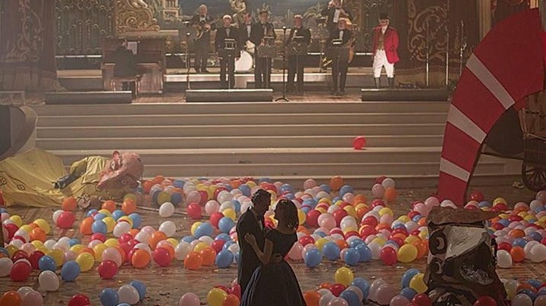 Daniel Day-Lewis and Vicky Krieps as Reynolds and Alma dancing in a ballroom filled with balloons in Phantom Thread