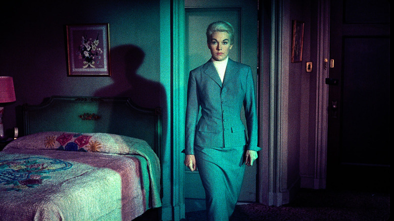 Kim Novak in gray suit and pinned-back blonde hair