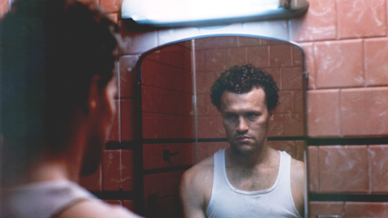 Michael Rooker as Henry looking at the mirror in Henry: Portrait of a Serial Killer