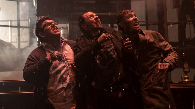 Gary, Andy, and Steven look skyward as they're bathed in red light in The World's End