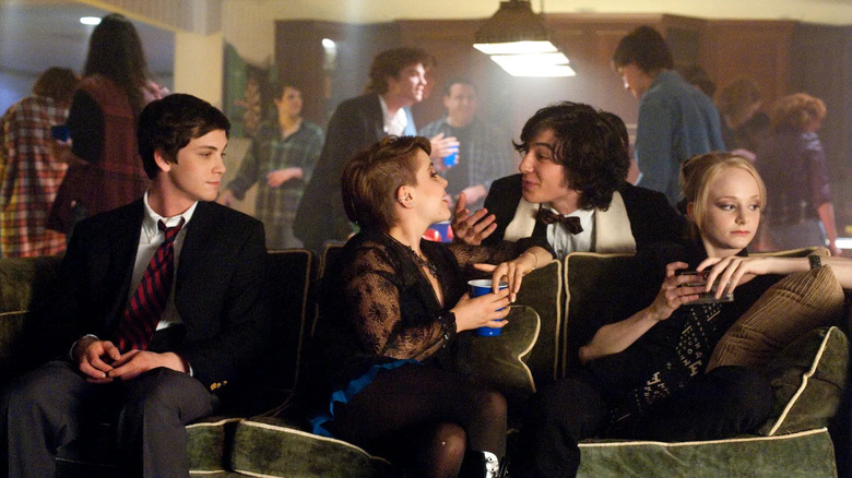 Charlie sits at the edge of a couch at a party in The Perks of Being a Wallflower