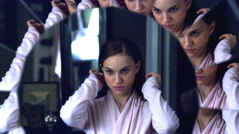 Nina looking into a multi-paneled glass mirror in Black Swan (2011)