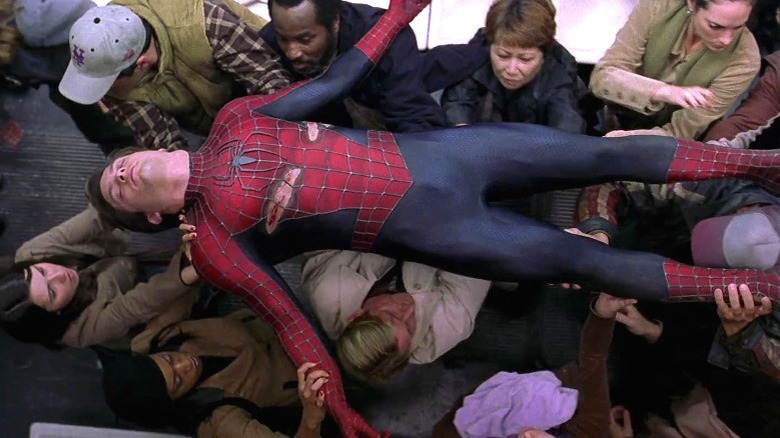 Subway crowd carrying woundedPeter Parker in Spider-Man 2