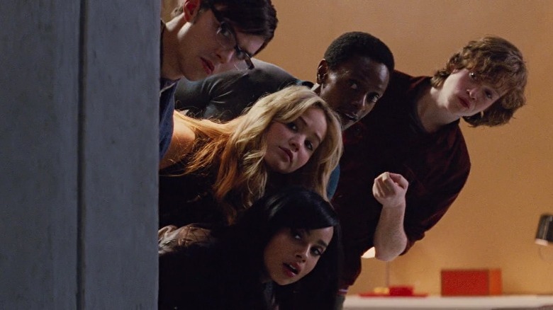 Hank, Darwin, Cassidy, Raven, and Angel peeking over a wall in X-Men: First Class