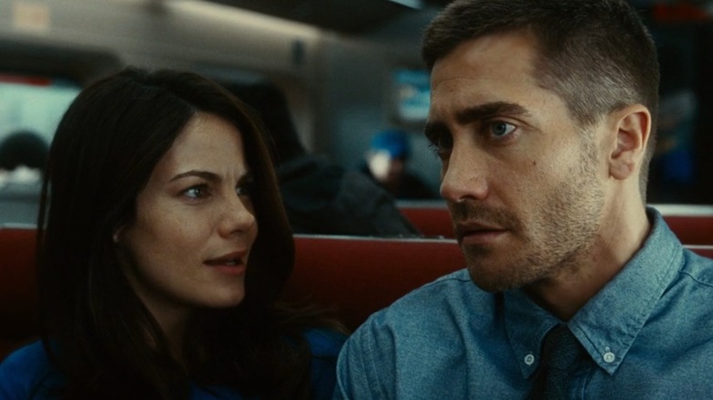 On a train, Christina looks at Colter, concerned, in Source Code