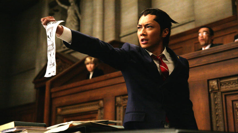 Phoenix Wright holding out papers in court