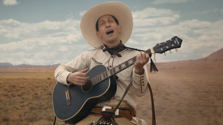 Tim Blake Nelson in The Ballad of Buster Scruggs plays guitar