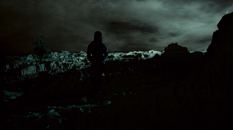 Young woman framed against storm.