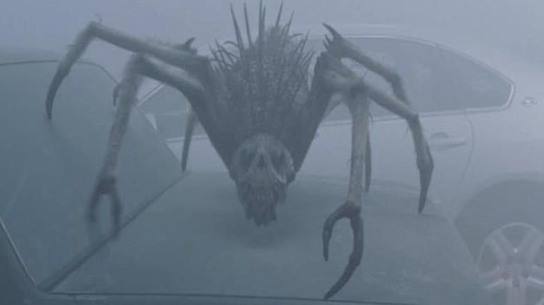 In the Mist's Giant spider atop car