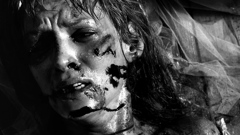 Uma Thurman, bloody, on the ground, looking away