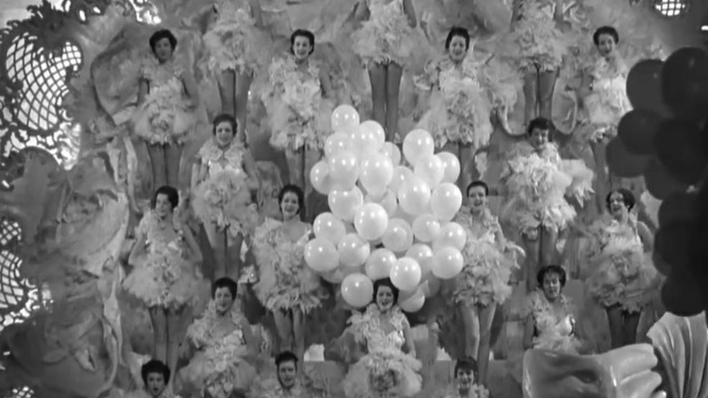 Women lined up and surrounded by balloons in a revue in The Great Ziegfeld