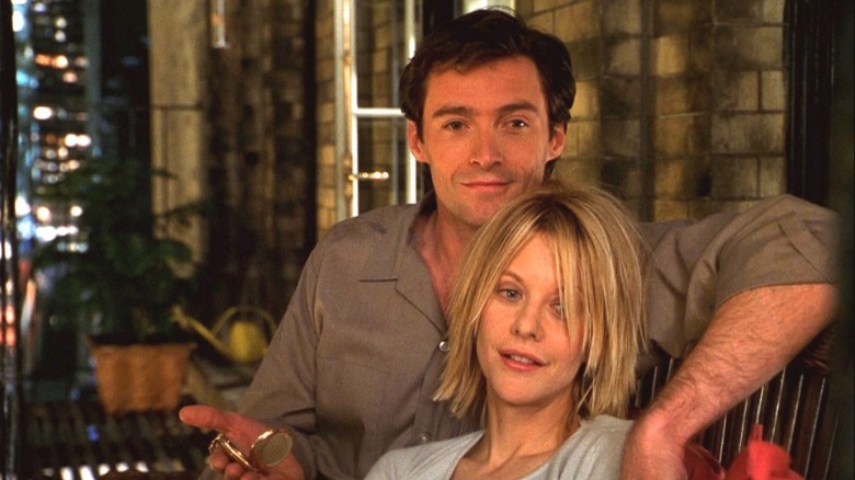 Kate and Leopold cuddling on their balcony