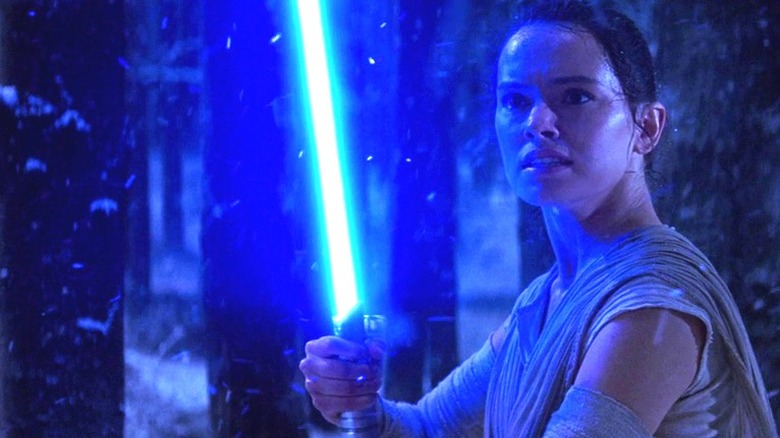 Rey lightsaber in snowy woods