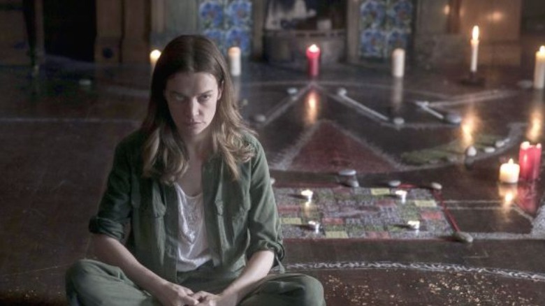 Sophia Howard sitting on the floor with candles