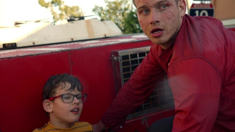 9-1-1's Buck and Christopher sitting on top of firetruck