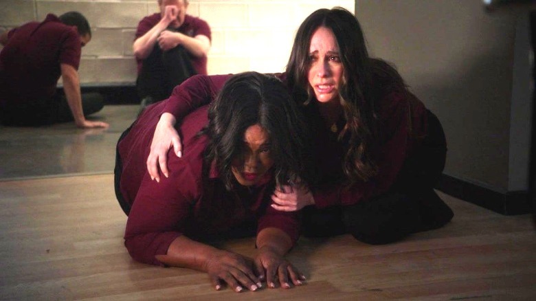 Maddie kneeling on floor with arms around Linda