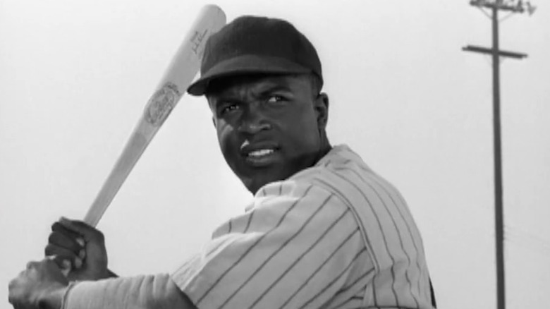 Jackie Robinson holding a baseball bat