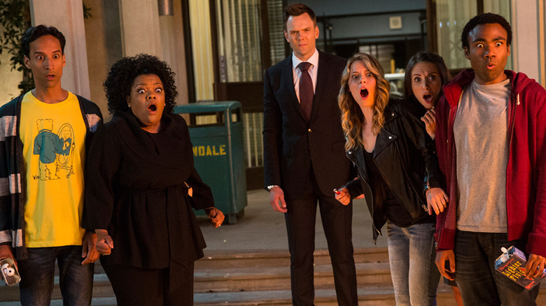 Danny Pudi, Yvette Nicole Brown, Joel McHale, Gillian Jacobs, Alison Brie, and Danny Glover on "Community" stare at fire