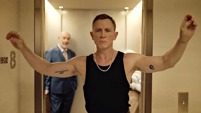 Daniel Craig dances down a hotel hallway