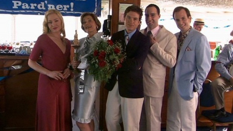 Bluth familiy pose for photo with flowers