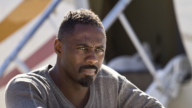 Idris Elba grimacing