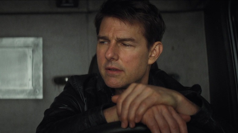 Ethan Hunt resting his hands on a steering wheel