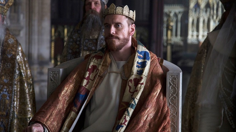 Michael Fassbender on throne in Macbeth
