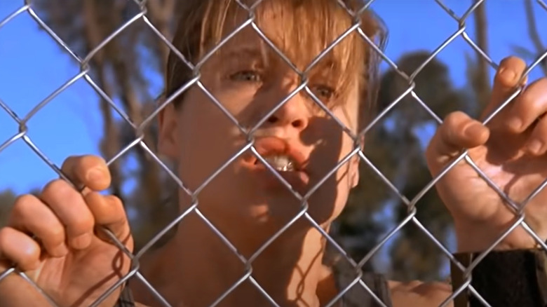 Sarah Connor holding onto fence