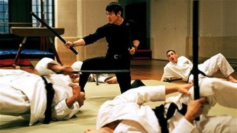 Jet Li fights prone figures