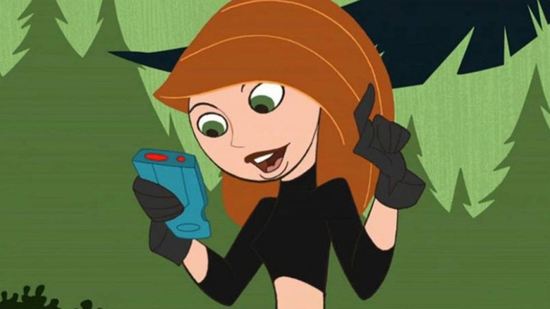 Kim looking at device in the woods on Kim Possible