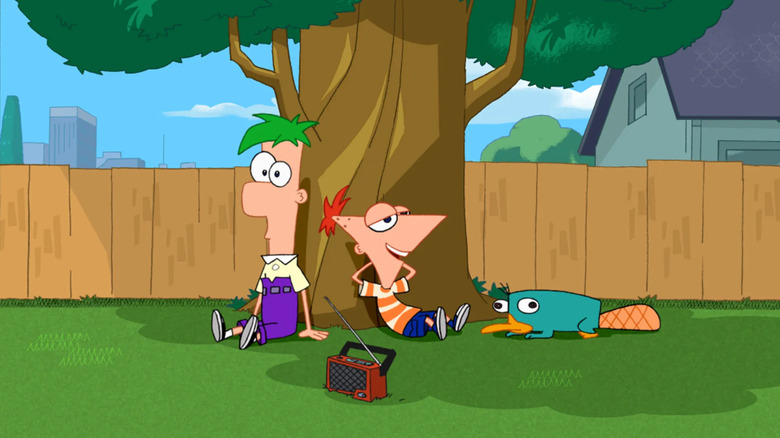 Phineas and Ferb leaning against a tree with Perry the Platypus