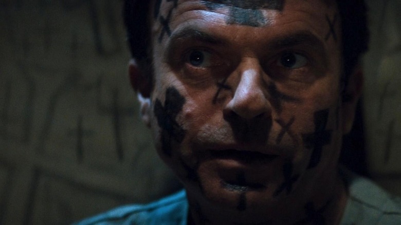 in the mouth of madness sam neill cowering