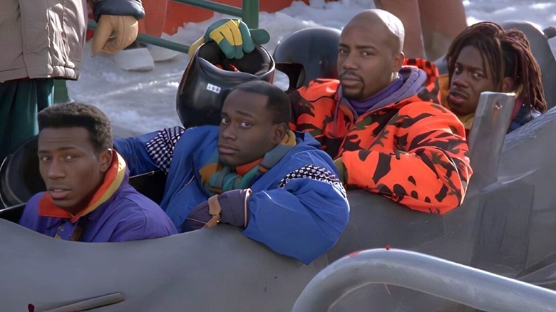 Leon as Derice Bannock, Rawle D. Lewis as Junior Bevil, Malik Yoba as Yul Brenner, and Doug E. Doug as Sanka Coffie sit in a bobsled in Cool Runnings